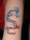 glitter dragon tattoo on arm